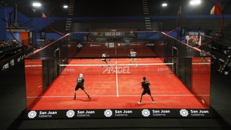 Personas jugando al pádel en una cancha de césped sintético en San Juan